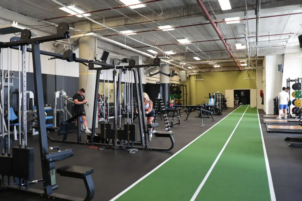 Compound Gym main floor with turf sprint lane