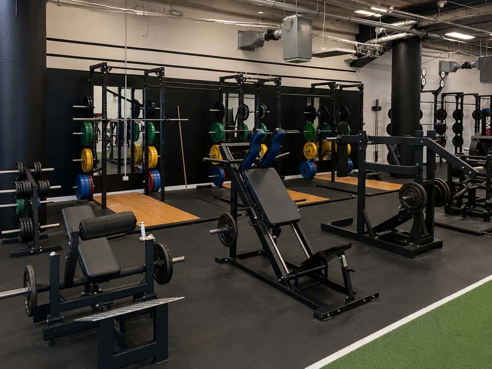 Plate-loaded machines, squat racks and lifting platforms at Compound Gym